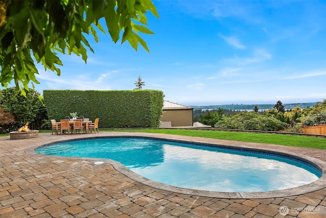 9620 NE 28th St, Clyde Hill, WA 98004 - view of swimming pool with a patio, a fire pit, outdoor dining space, and a lawn
