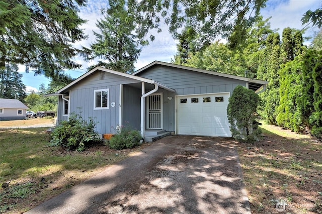 2059 Beverly Blvd, Shelton, WA 98584 - ranch-style house featuring asphalt driveway, a garage, and board and batten siding