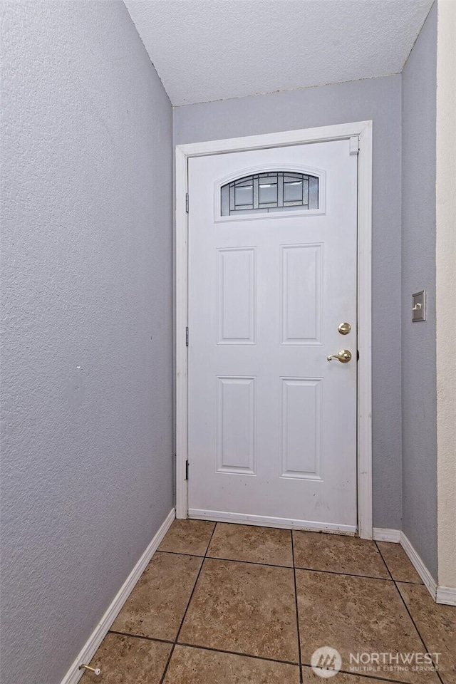 2059 Beverly Blvd, Shelton, WA 98584 - doorway with tile patterned floors, a textured wall, and a textured ceiling