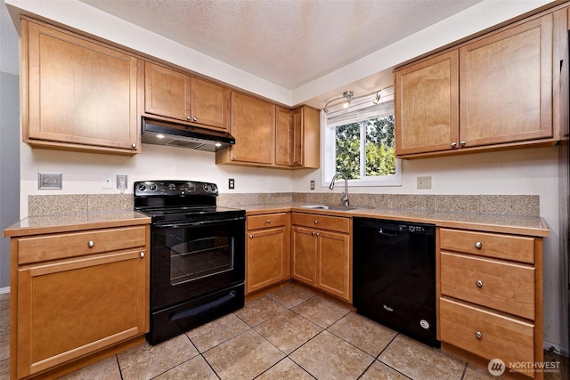 2059 Beverly Blvd, Shelton, WA 98584 - kitchen featuring black appliances, under cabinet range hood, tile countertops, light tile patterned floors, and a textured ceiling