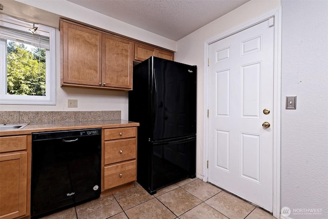 2059 Beverly Blvd, Shelton, WA 98584 - kitchen featuring black appliances, light tile patterned flooring, a textured ceiling, and brown cabinets