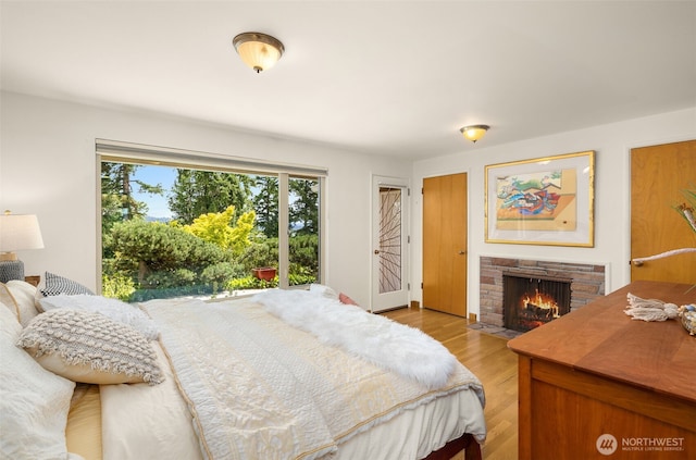 3912 NE 127th St, Seattle, WA 98125 - bedroom featuring a stone fireplace and light wood-style floors