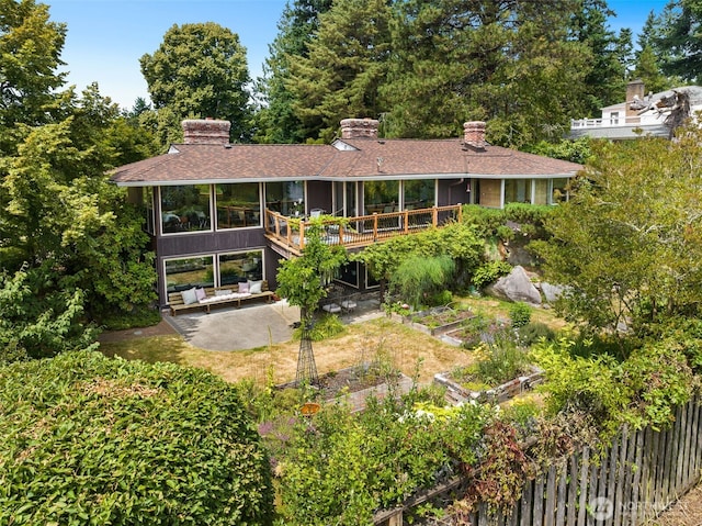 3912 NE 127th St, Seattle, WA 98125 - back of house featuring a garden, a patio, a wooden deck, and a chimney
