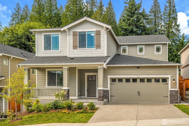 3941 233rd St SE, Bothell, WA 98021 - craftsman-style home featuring covered porch, concrete driveway, a garage, a shingled roof, and stone siding