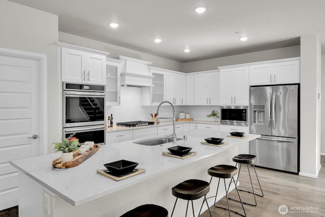 3941 233rd St SE, Bothell, WA 98021 - kitchen featuring appliances with stainless steel finishes, custom exhaust hood, white cabinetry, backsplash, and recessed lighting