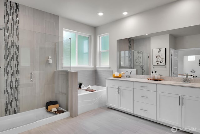 3941 233rd St SE, Bothell, WA 98021 - bathroom with a garden tub, a stall shower, double vanity, and recessed lighting