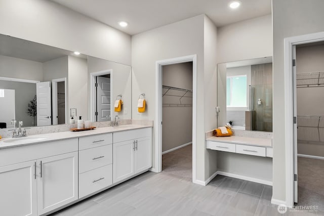 3941 233rd St SE, Bothell, WA 98021 - full bathroom featuring a walk in closet, double vanity, a shower stall, and recessed lighting