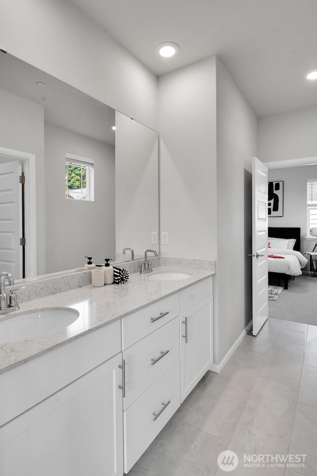 3941 233rd St SE, Bothell, WA 98021 - bathroom with double vanity, ensuite bath, plenty of natural light, and recessed lighting