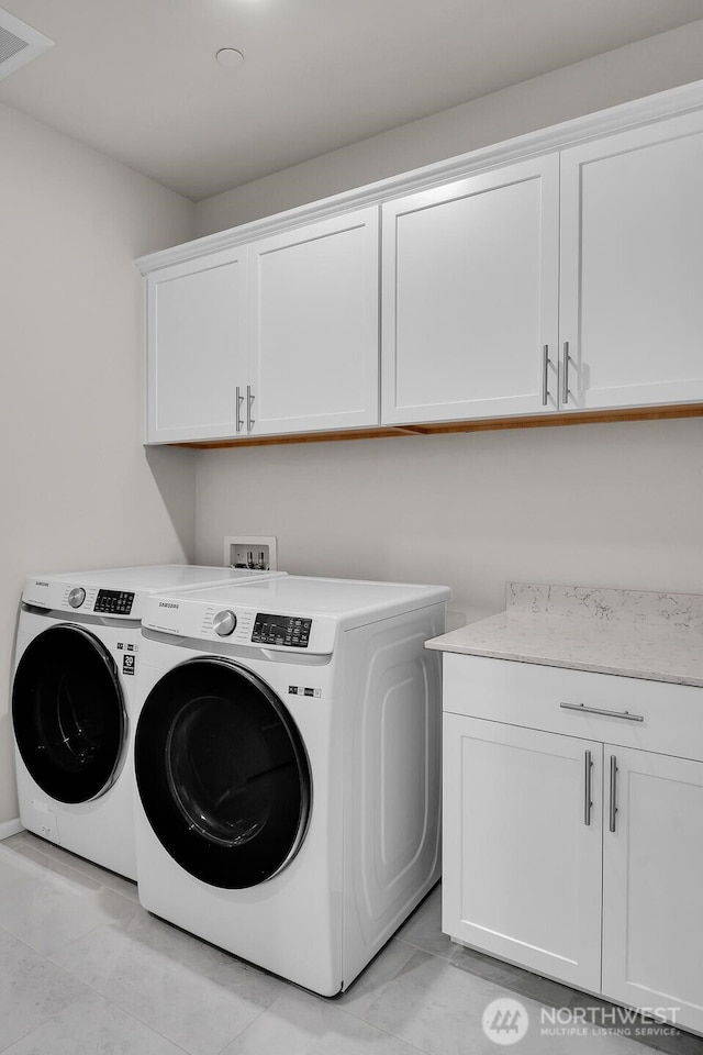 3941 233rd St SE, Bothell, WA 98021 - laundry room with cabinet space, washer and dryer, and light tile patterned flooring