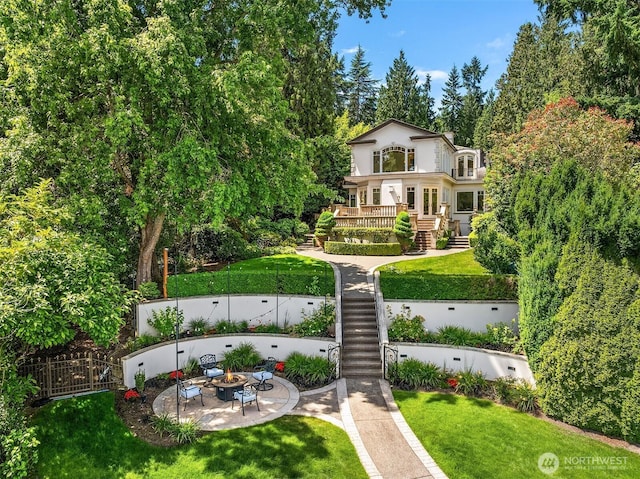 3210 Hunts Point Rd, Hunts Point, WA 98004 - fenced yard featuring a fire pit, stairway, a wooden deck, a gate, and a patio area