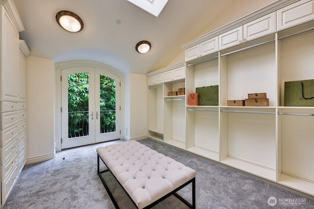 3210 Hunts Point Rd, Hunts Point, WA 98004 - bedroom with light colored carpet, french doors, access to outside, a skylight, and vaulted ceiling