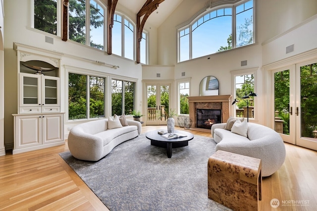 3210 Hunts Point Rd, Hunts Point, WA 98004 - living area with a high ceiling, french doors, light wood-style floors, and a fireplace