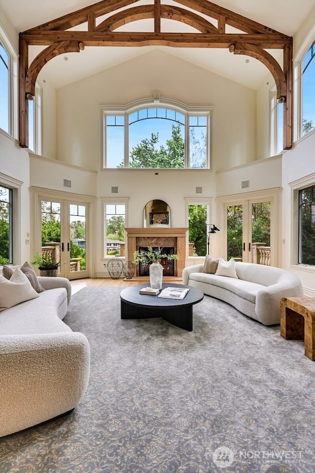 3210 Hunts Point Rd, Hunts Point, WA 98004 - living area featuring high vaulted ceiling, french doors, a fireplace, and beam ceiling