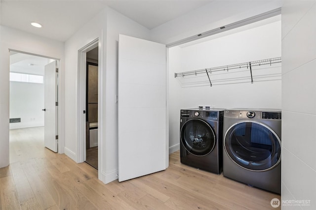 805 Taylor Ave N Unit D, Seattle, WA 98109 - laundry room featuring light wood-type flooring, independent washer and dryer, and recessed lighting