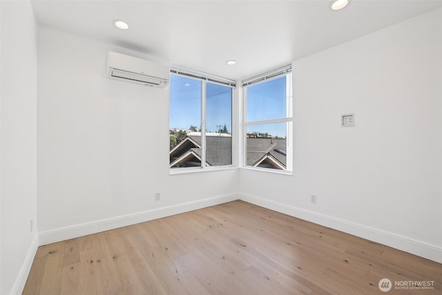 805 Taylor Ave N Unit D, Seattle, WA 98109 - spare room featuring a wall unit AC, wood finished floors, and recessed lighting