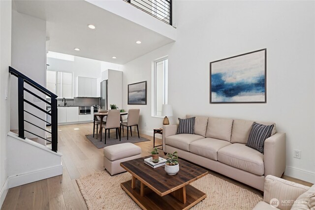 805 Taylor Ave N Unit D, Seattle, WA 98109 - living area featuring light wood-style flooring, stairs, recessed lighting, and a high ceiling
