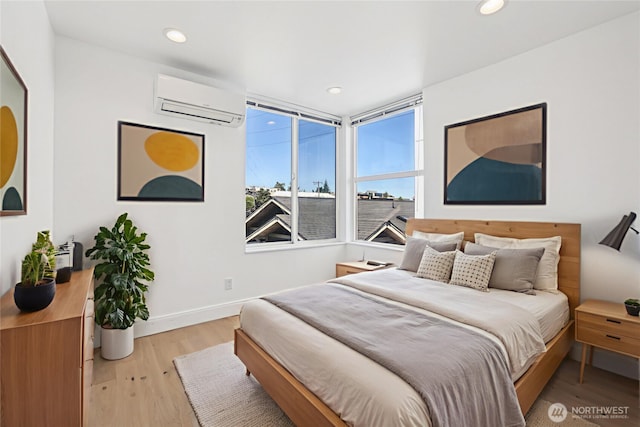 805 Taylor Ave N Unit D, Seattle, WA 98109 - bedroom with a wall unit AC, light wood-style flooring, and recessed lighting