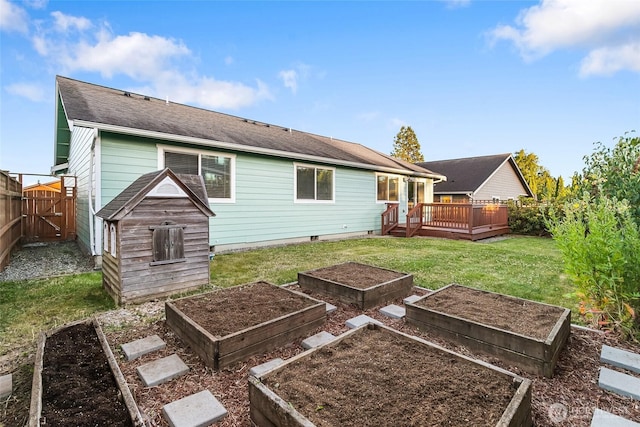 5983 Honeycutt Ct, Ferndale, WA 98248 - back of property featuring a garden, a wooden deck, a fenced backyard, and a gate