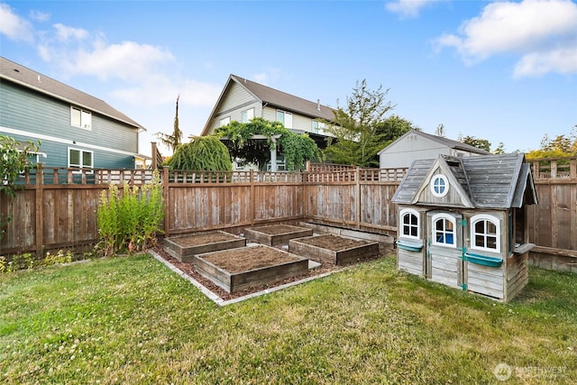 5983 Honeycutt Ct, Ferndale, WA 98248 - fenced backyard featuring a garden and an outbuilding