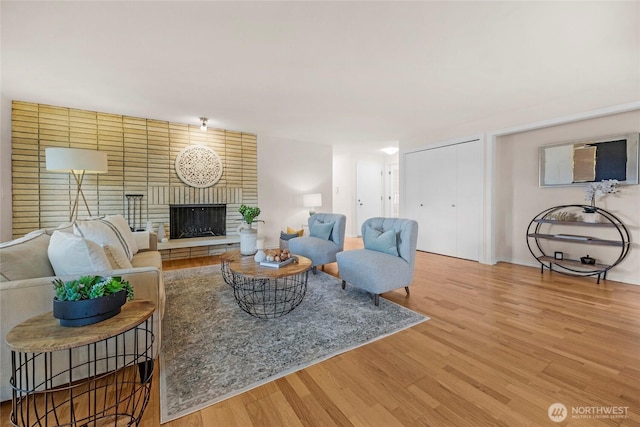 13573 Linden Ave N Unit 302, Seattle, WA 98133 - living room featuring wood finished floors and a brick fireplace