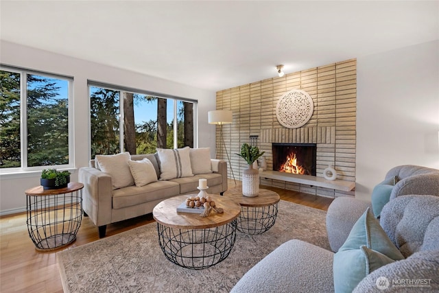 13573 Linden Ave N Unit 302, Seattle, WA 98133 - living area with wood finished floors, plenty of natural light, and a brick fireplace