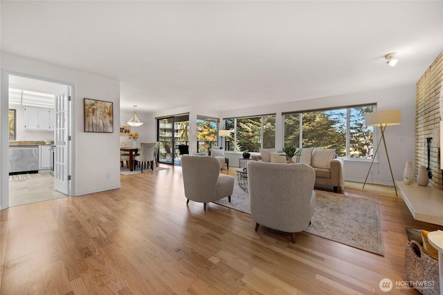 13573 Linden Ave N Unit 302, Seattle, WA 98133 - living room featuring plenty of natural light and light wood-style flooring