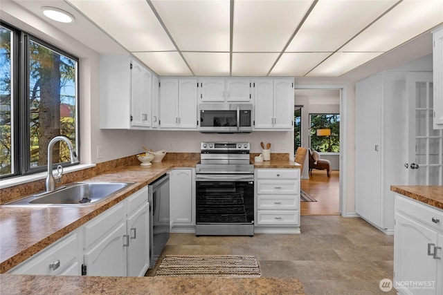 13573 Linden Ave N Unit 302, Seattle, WA 98133 - kitchen with stainless steel appliances and white cabinets