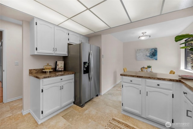 13573 Linden Ave N Unit 302, Seattle, WA 98133 - kitchen with stainless steel refrigerator with ice dispenser, dark countertops, white cabinetry, and a peninsula