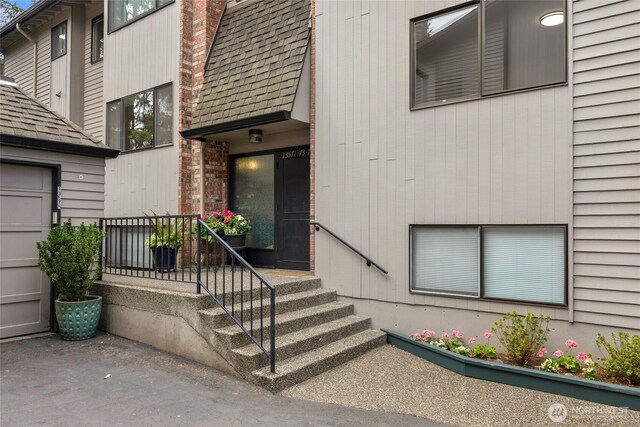 13573 Linden Ave N Unit 302, Seattle, WA 98133 - property entrance with roof with shingles and a chimney