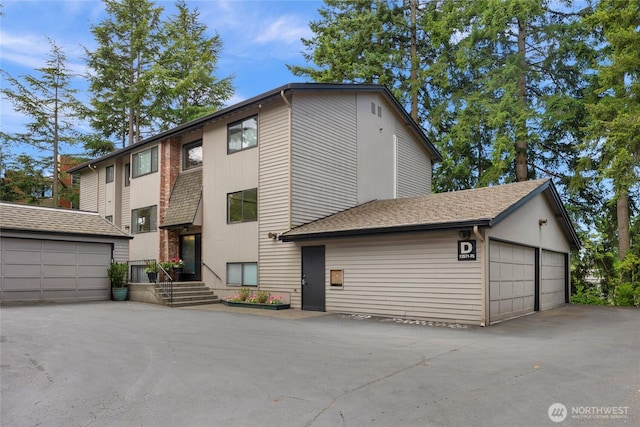 13573 Linden Ave N Unit 302, Seattle, WA 98133 - view of front of home featuring a garage and an outbuilding