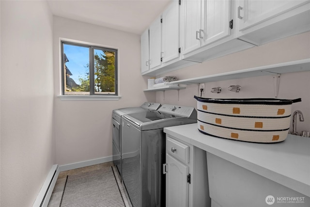 13573 Linden Ave N Unit 302, Seattle, WA 98133 - laundry room with cabinet space, washing machine and clothes dryer, baseboard heating, and tile patterned floors