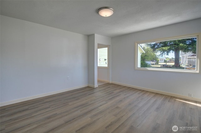 408 N 11th St, Elma, WA 98541 - empty room featuring wood finished floors and baseboards