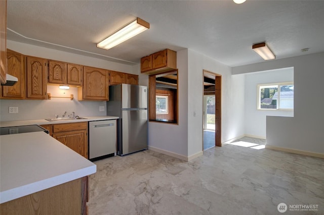 408 N 11th St, Elma, WA 98541 - kitchen featuring stainless steel appliances, light countertops, and brown cabinetry