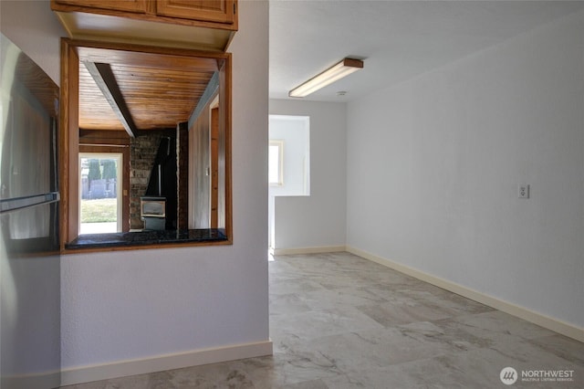 408 N 11th St, Elma, WA 98541 - unfurnished room featuring plenty of natural light, a wood stove, and wood ceiling