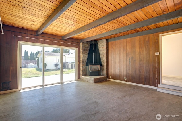 408 N 11th St, Elma, WA 98541 - unfurnished living room featuring wood walls, a wood ceiling with exposed beams, and a wood stove