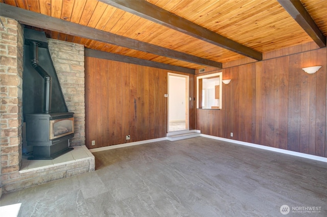 408 N 11th St, Elma, WA 98541 - unfurnished living room with a wood stove, a wood ceiling with exposed beams, and wooden walls