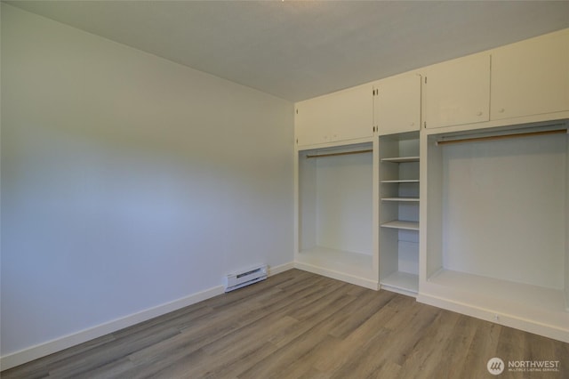 408 N 11th St, Elma, WA 98541 - unfurnished bedroom featuring baseboard heating and wood finished floors