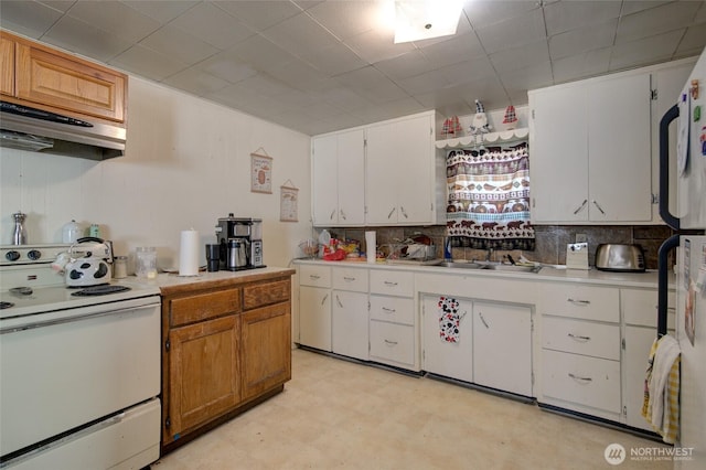 408 N 11th St, Elma, WA 98541 - kitchen with white appliances, range hood, light countertops, white cabinets, and backsplash