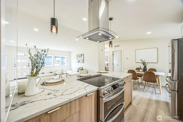 1322 Crescent Ave, Centralia, WA 98531 - kitchen with stainless steel appliances, island exhaust hood, modern cabinets, open floor plan, and light wood-style flooring