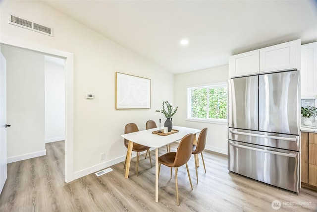 1322 Crescent Ave, Centralia, WA 98531 - dining room with light wood-type flooring, vaulted ceiling, and recessed lighting