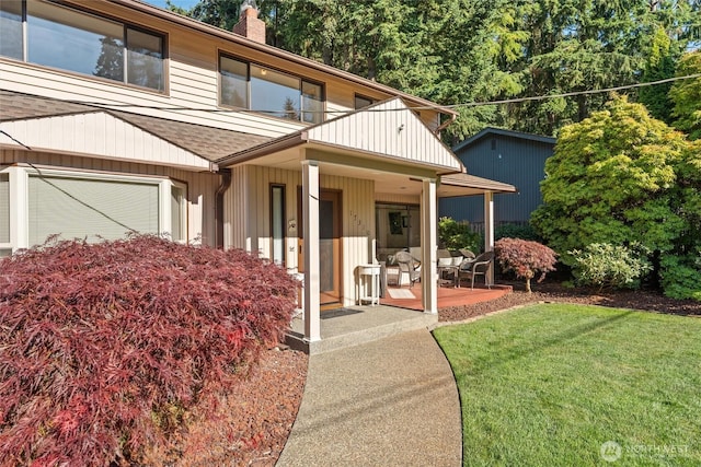 17310 Palatine Ave N, Shoreline, WA 98133 - view of front of home with covered porch, a chimney, and a front yard