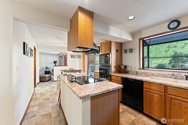 17310 Palatine Ave N, Shoreline, WA 98133 - kitchen featuring black appliances, a kitchen island, brown cabinets, recessed lighting, and light stone countertops