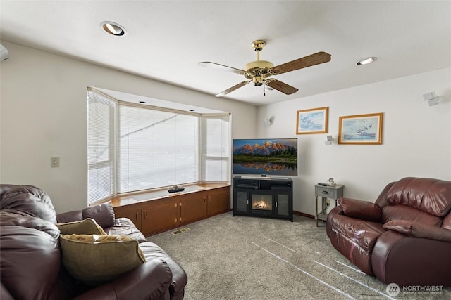 17310 Palatine Ave N, Shoreline, WA 98133 - living room featuring ceiling fan, light colored carpet, recessed lighting, and a glass covered fireplace