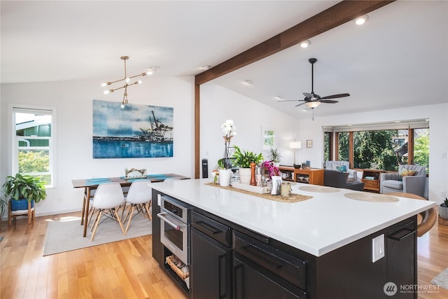 14785 Channel Dr, La Conner, WA 98257 - kitchen with dark cabinets, light countertops, ceiling fan, and healthy amount of natural light