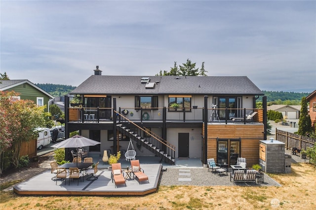 14785 Channel Dr, La Conner, WA 98257 - rear view of property with a deck, stairs, a patio area, and roof with shingles