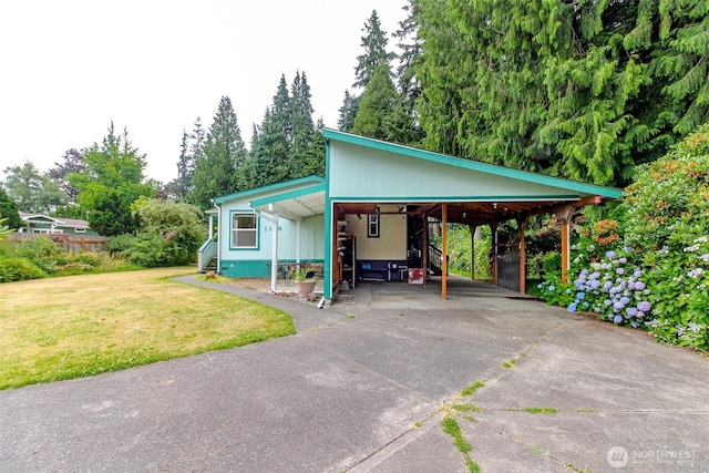 1106 29th St SE, Auburn, WA 98002 - view of front facade featuring a front yard, driveway, an attached carport, and view of scattered trees