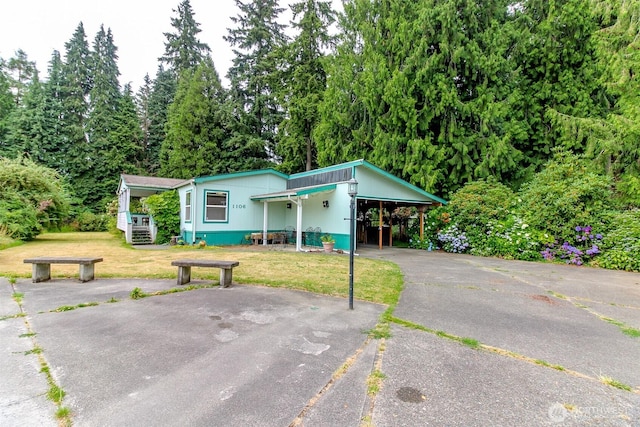 1106 29th St SE, Auburn, WA 98002 - view of front of house with asphalt driveway, a front yard, and an attached carport