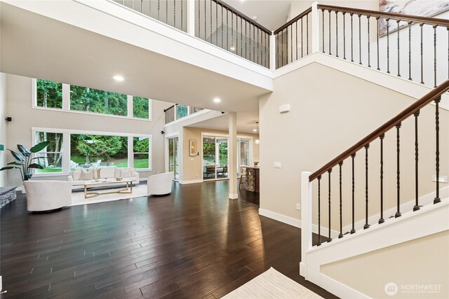 24130 145th Ave SE, Snohomish, WA 98296 - living room featuring a towering ceiling, wood finished floors, stairway, and recessed lighting