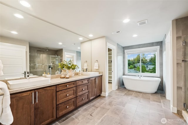 24130 145th Ave SE, Snohomish, WA 98296 - bathroom with a shower stall, double vanity, a freestanding tub, recessed lighting, and a walk in closet