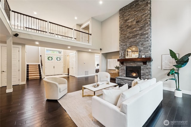24130 145th Ave SE, Snohomish, WA 98296 - living room featuring stairs, wood-type flooring, a towering ceiling, a fireplace, and recessed lighting